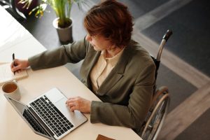 work-smarter-not-harder-navigating-sga-exceptions-image – SSLG – SSLG professional with disability working in modern office, SSDI SGA eligibility - substantial gainful activity exceptions